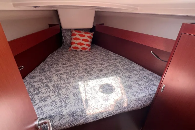 Slide: The Image of Cozy cabin interior of 2019 Dehler 34 yacht with patterned bedding and pillow. - 45