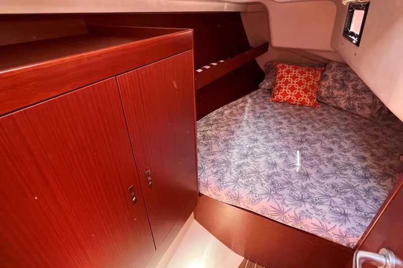 Slide: The Image of Cozy cabin interior of 2019 Dehler 34 yacht with wood cabinetry and patterned bedding. - 46