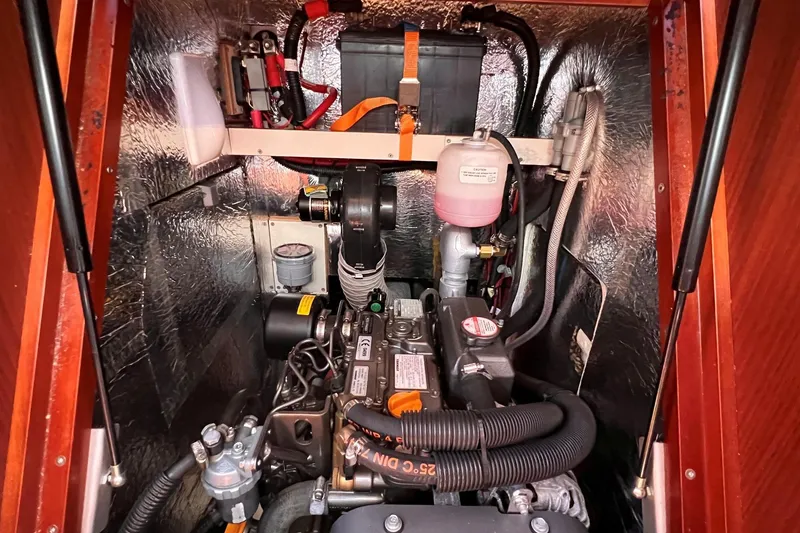 Slide: The Image of Engine compartment of a 2019 Dehler 34 sailboat, showcasing mechanical components and battery. - 49