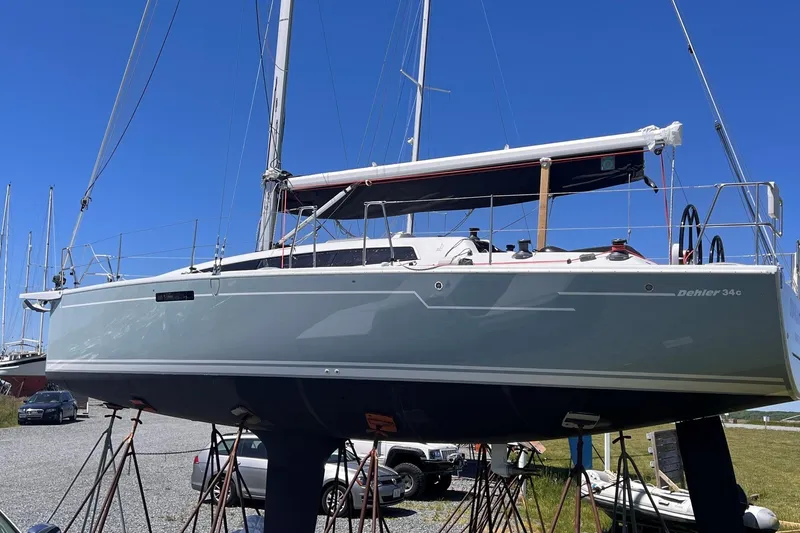Slide: The Image of 2019 Dehler 34c sailboat anchored in a calm harbor with clear skies. - 6
