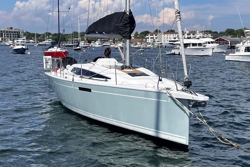 Slide: The Image of 2019 Dehler 34 sailboat anchored in a busy marina with other boats. - 2