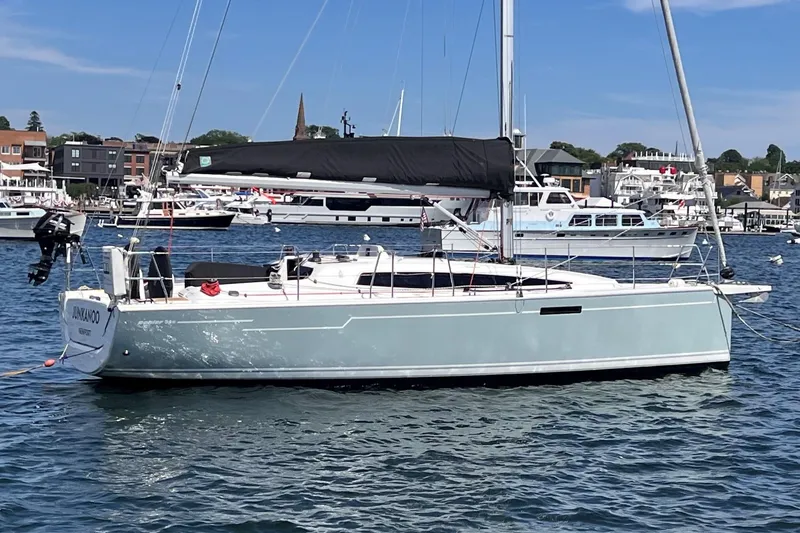 The Image of 2019 Dehler 34 sailboat docked in a marina, featuring a sleek design and black sail. - 0