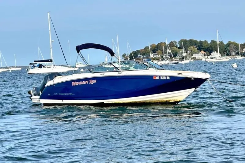 The Image of 2020 Regal 23 OBX boat anchored on water with scenic background. - 1