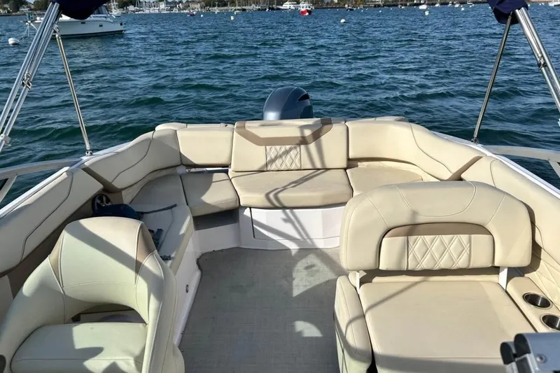 Slide: The Image of 2020 Regal 23 OBX boat interior with beige seating, on a calm lake. - 3