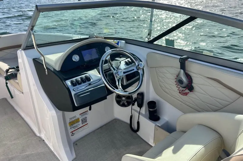 Slide: The Image of Cockpit of 2020 Regal 23 OBX boat with steering wheel and dashboard controls. - 4