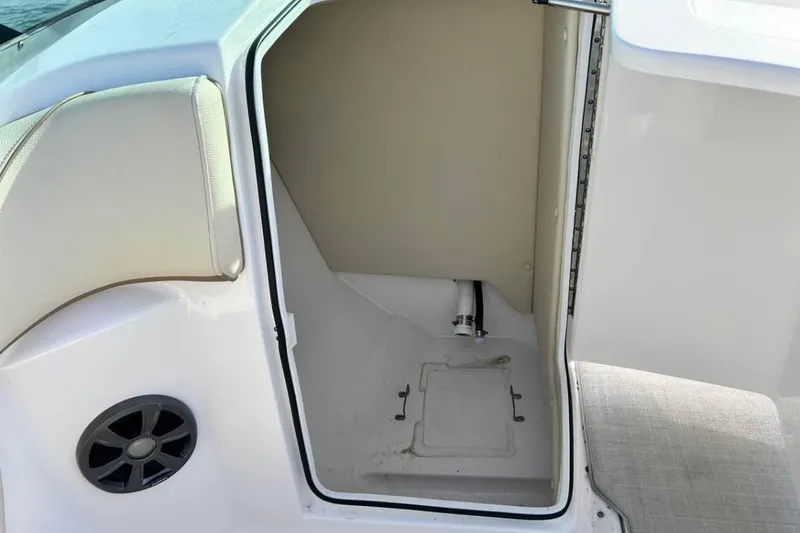 Slide: The Image of Open storage compartment on a 2020 Regal 23 OBX boat, featuring interior details. - 6