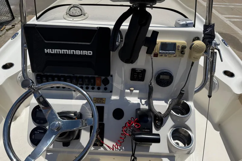 Slide: The Image of 2019 Key West 230 Bay Reef boat console with steering wheel and navigation equipment. - 11