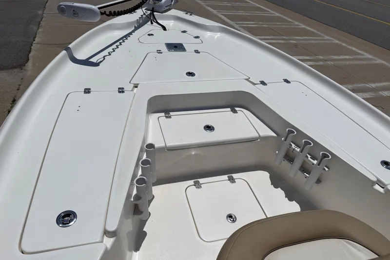 Slide: The Image of 2019 Key West 230 Bay Reef boat deck with storage compartments and rod holders. - 14