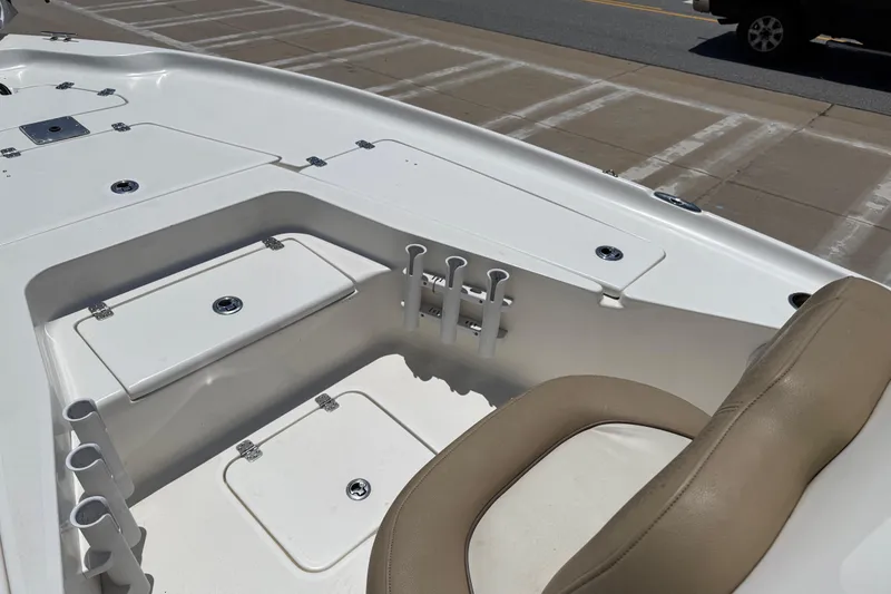 Slide: The Image of 2019 Key West 230 Bay Reef boat interior with storage compartments and seating. - 15
