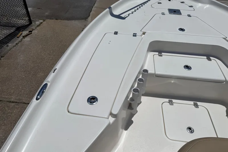 Slide: The Image of 2019 Key West 230 Bay Reef boat deck with storage compartments and rod holders. - 16