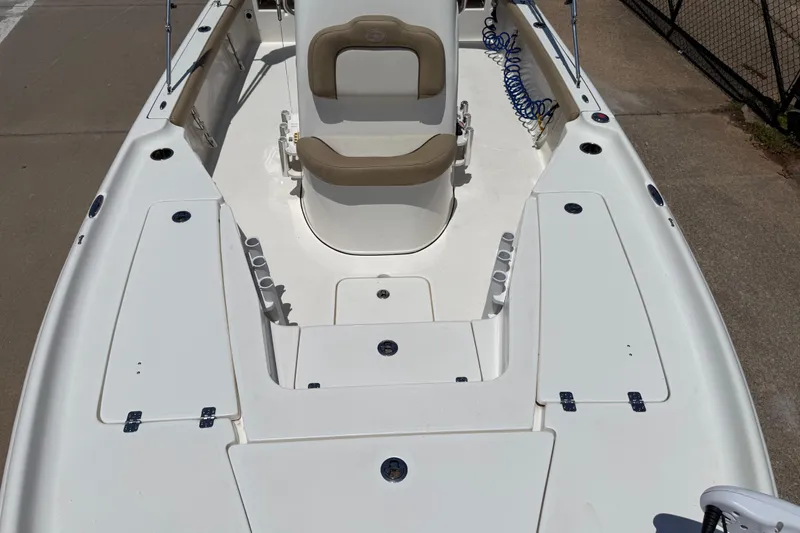 Slide: The Image of 2019 Key West 230 Bay Reef boat interior with seating and storage compartments. - 19