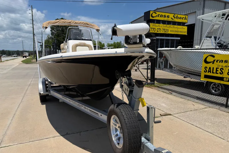Slide: The Image of 2019 Key West 230 Bay Reef boat on trailer at dealership, sunny day. - 2