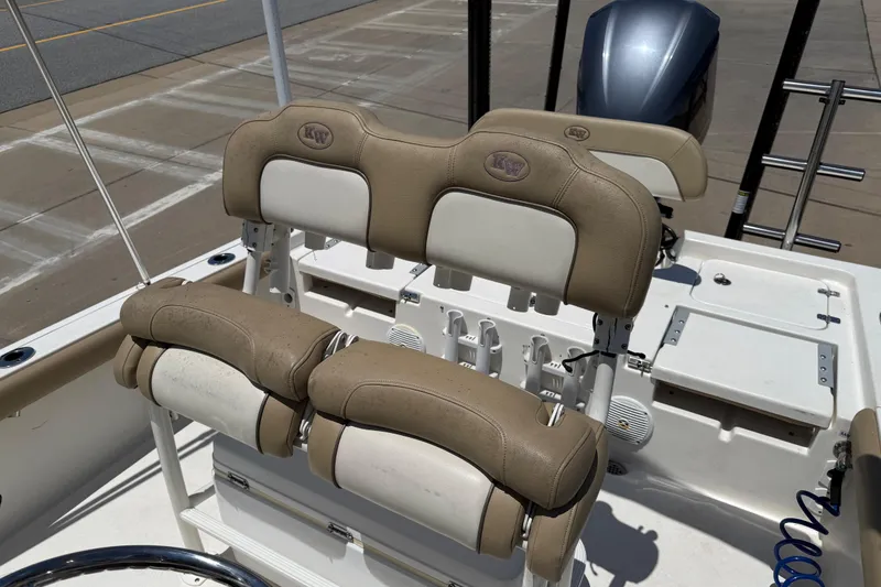 Slide: The Image of 2019 Key West 230 Bay Reef boat interior with tan seating and motor. - 21