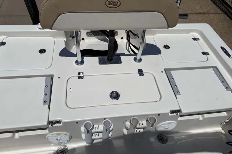 Slide: The Image of 2019 Key West 230 Bay Reef boat deck with storage compartments and rod holders. - 23
