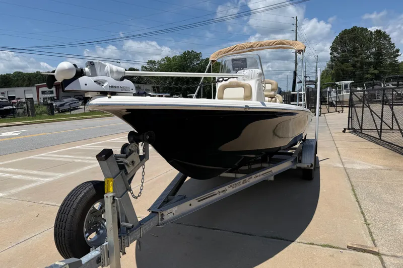 Slide: The Image of 2019 Key West 230 Bay Reef boat on trailer, parked outdoors under clear sky. - 3