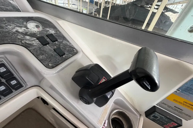 Slide: The Image of 1998 Formula 280 Sun Sport boat control panel with throttle lever and switches. - 11
