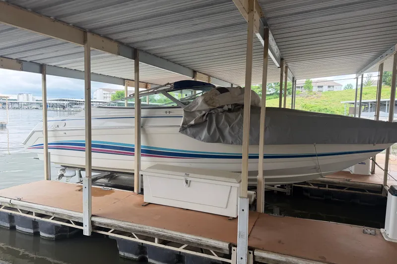 Slide: The Image of 1998 Formula 280 Sun Sport boat docked under a covered marina. - 2