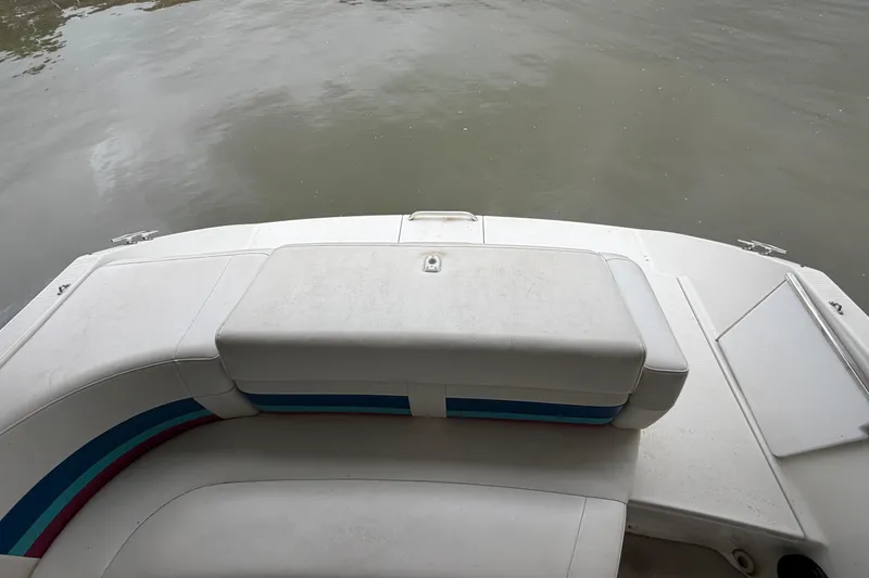 Slide: The Image of 1998 Formula 280 Sun Sport boat interior with white seating, near calm water. - 5