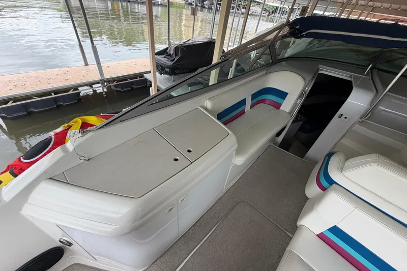 Slide: The Image of 1998 Formula 280 Sun Sport boat interior with colorful seating and dock view. - 7