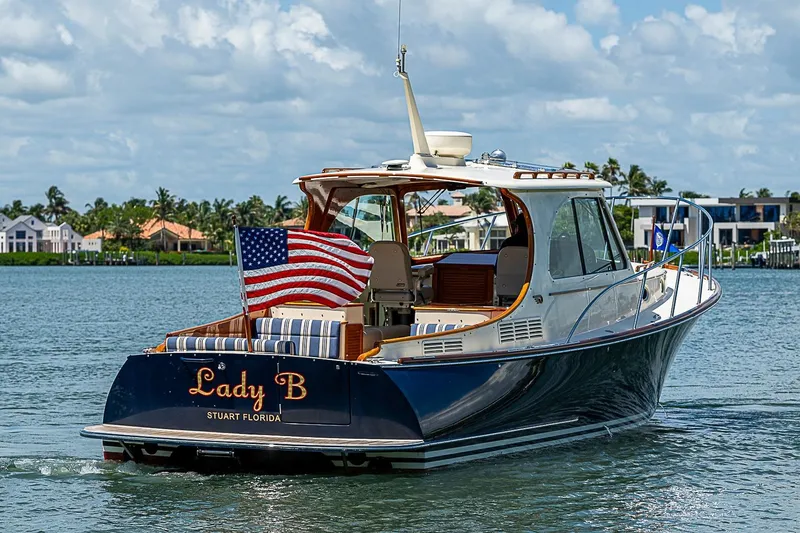 The Image of 2016 Hinckley Picnic Boat 37 MKIII cruising on water with American flag. - 0