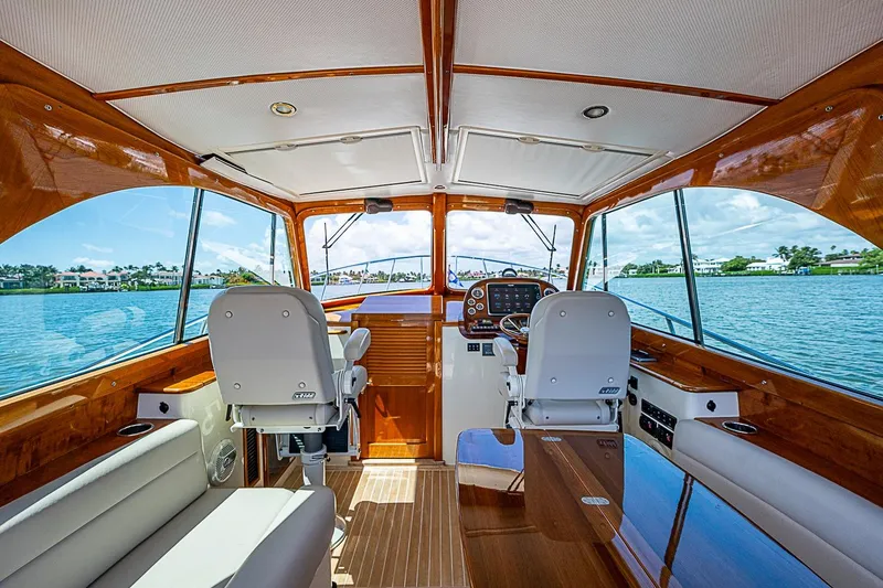 Slide: The Image of Interior of 2016 Hinckley Picnic Boat 37 MKIII with luxurious wood finish and waterfront view. - 13