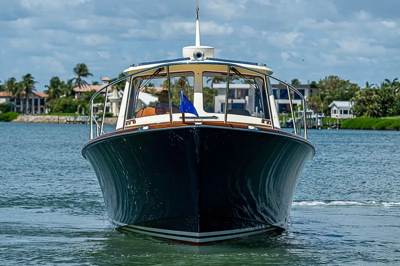 Slide: The Image of 2016 Hinckley Picnic Boat 37 MKIII cruising on a sunny day near waterfront homes. - 2