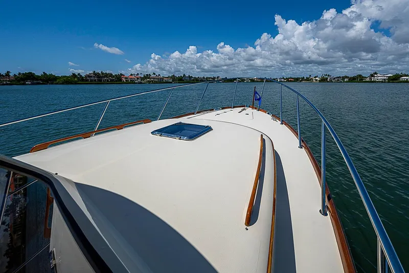 Slide: The Image of 2016 Hinckley Picnic Boat 37 MKIII cruising on calm waters under a clear blue sky. - 20