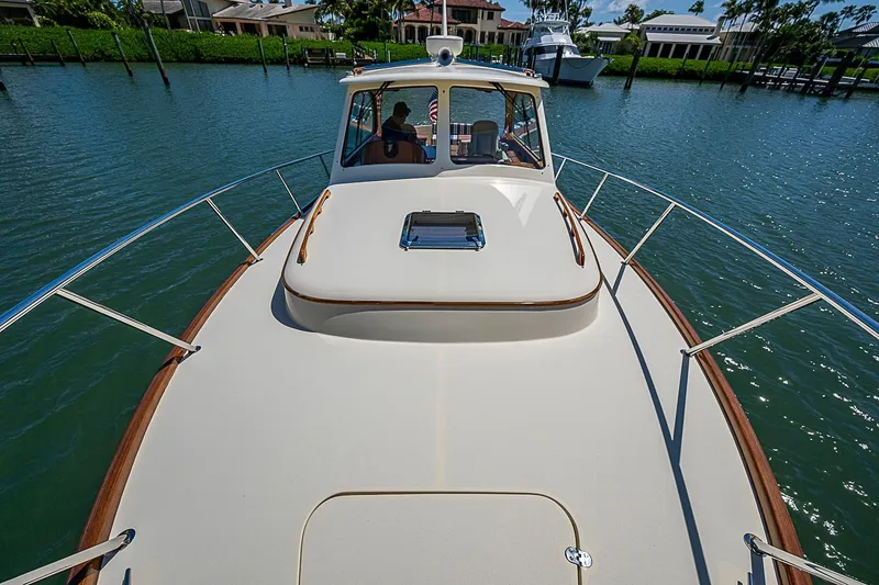 Slide: The Image of Hinckley Picnic Boat 37 MKIII, 2016 model, cruising on calm waters near a marina. - 22
