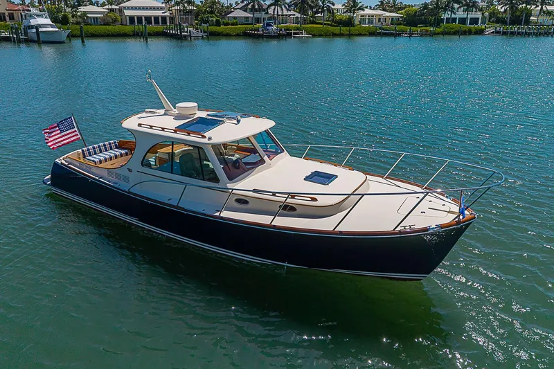 Slide: The Image of 2016 Hinckley Picnic Boat 37 MKIII cruising on a sunny day in calm waters. - 3