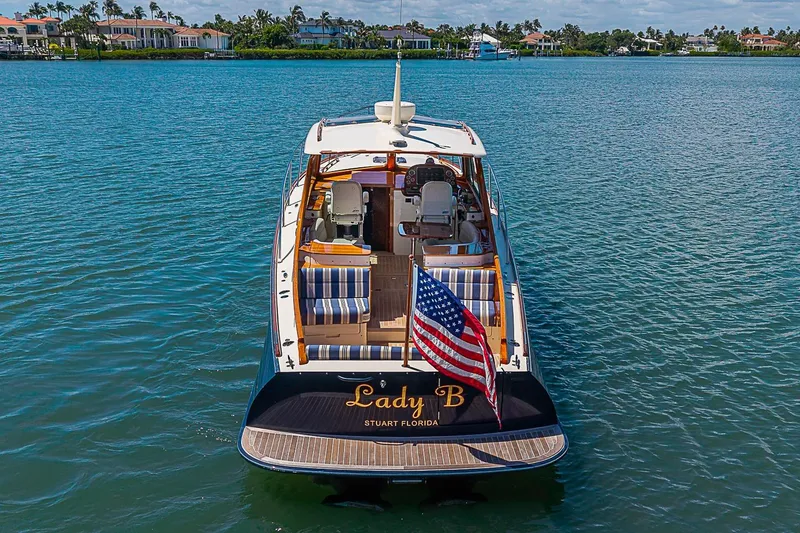 Slide: The Image of Hinckley Picnic Boat 37 MKIII, 2016, on water with American flag, luxury seating. - 4