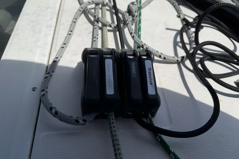Slide: The Image of Rope clutches on a 2007 Beneteau 343 sailboat deck, labeled Spin Halyard, Outhaul, Traveler. - 15