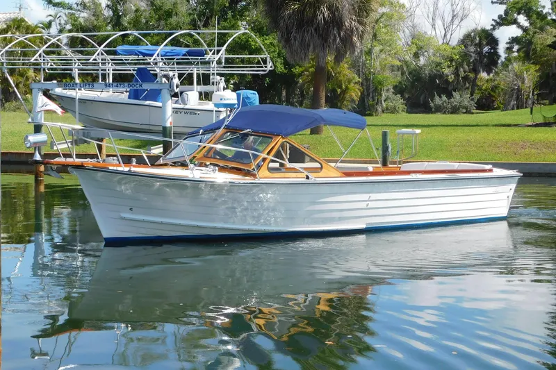 The Image of 1995 Lyman 27 Cruisette boat on calm water. - 0