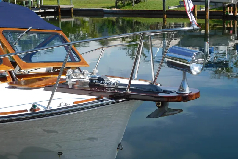 Slide: The Image of Bow of a 1995 Lyman 27 Cruisette boat with polished wood and chrome details. - 10