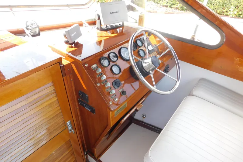 Slide: The Image of Interior of a 1995 Lyman 27 Cruisette boat with wooden dashboard and steering wheel. - 15