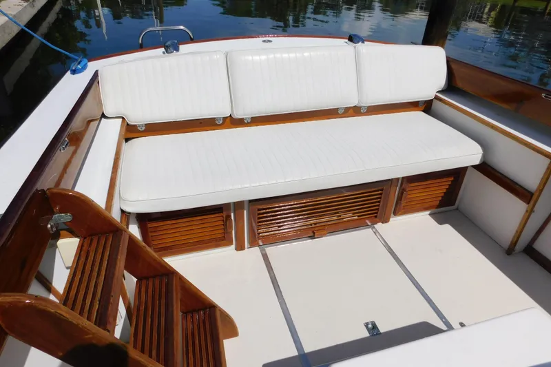 Slide: The Image of White cushioned seating on a 1995 Lyman 27 Cruisette boat deck. - 21