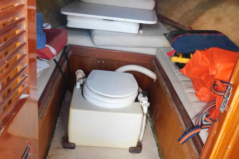 Slide: The Image of Interior of a 1995 Lyman 27 Cruisette with toilet and cushions. - 27