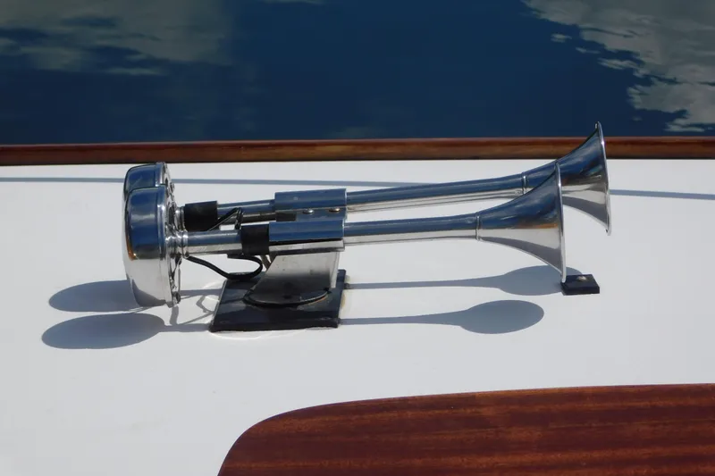 Slide: The Image of Chrome boat horn on a 1995 Lyman 27 Cruisette, reflecting sunlight. - 30