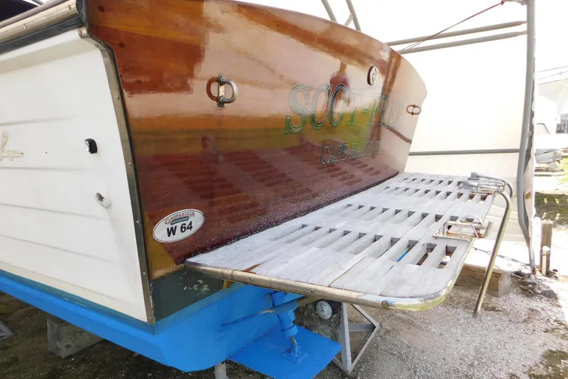 Slide: The Image of 1995 Lyman 27 Cruisette boat with wooden stern and swim platform in dry dock. - 39