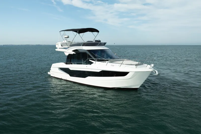 The Image of 2023 Galeon 400 Fly yacht cruising on open water under a clear sky. - 0