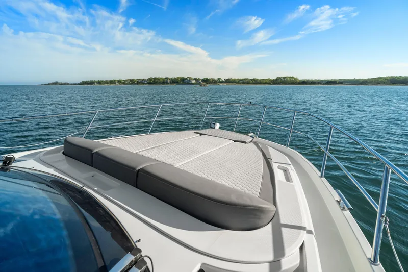 Slide: The Image of 2023 Galeon 400 Fly yacht with sunbed, cruising on serene waters under a clear blue sky. - 15