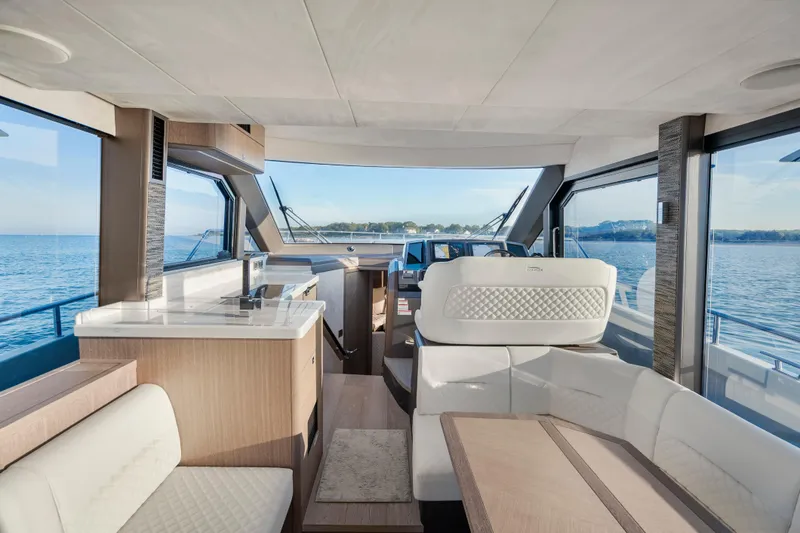 Slide: The Image of Luxurious interior of 2023 Galeon 400 Fly yacht with panoramic windows and elegant seating. - 18