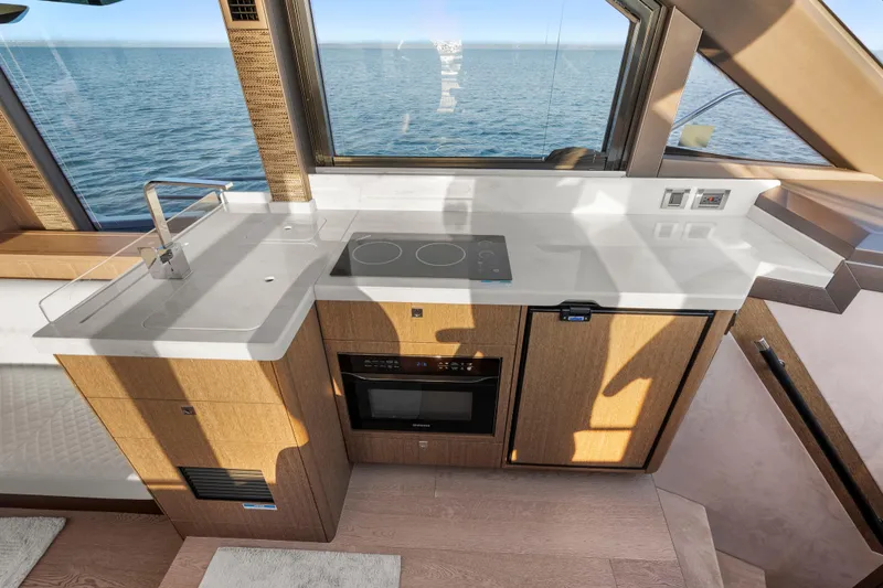 Slide: The Image of Modern kitchen on 2023 Galeon 400 Fly yacht with ocean view, featuring sleek countertops and appliances. - 21
