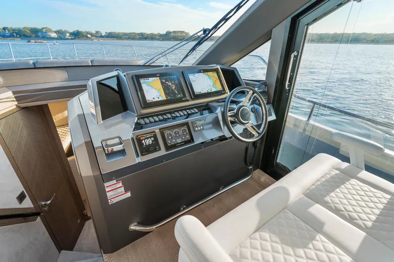 Slide: The Image of Helm of 2023 Galeon 400 Fly yacht with navigation screens and steering wheel. - 23
