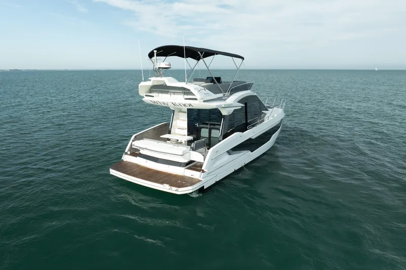 Slide: The Image of 2023 Galeon 400 Fly yacht on open water, showcasing sleek design and spacious deck. - 4