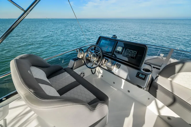 Slide: The Image of 2023 Galeon 400 Fly yacht helm with modern controls and ocean view. - 43