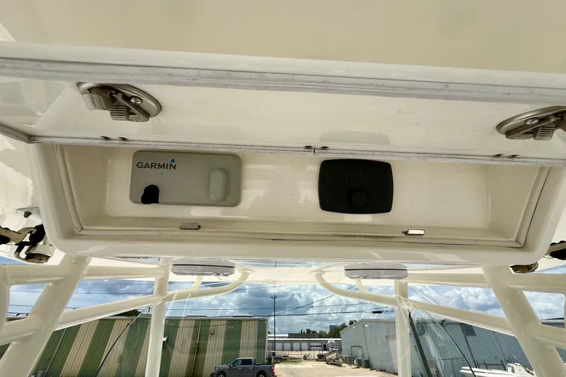 Slide: The Image of 2017 Regulator 28 boat electronics compartment with Garmin and Polk devices. - 10