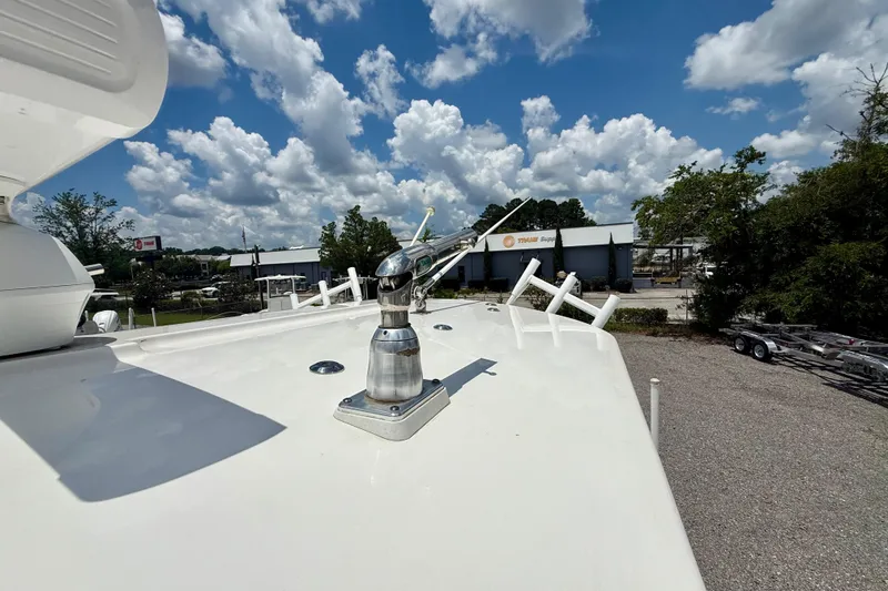 Slide: The Image of 2017 Regulator 28 boat deck with antenna, under a partly cloudy sky. - 9