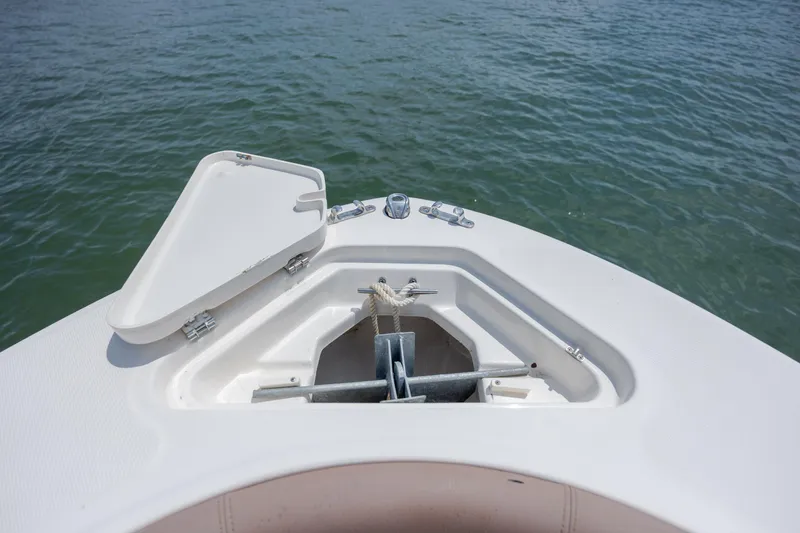 Slide: The Image of Bow of 2022 Pioneer 202 Islander boat with anchor compartment open. - 12