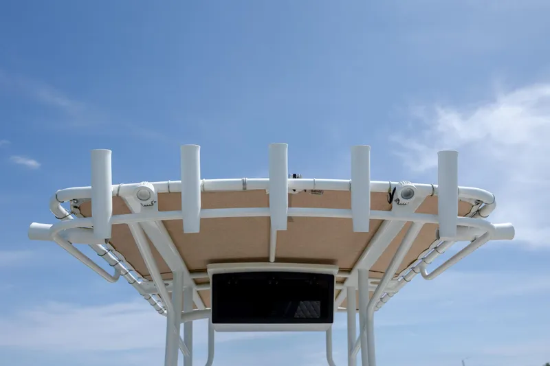 Slide: The Image of T-top of 2022 Pioneer 202 Islander boat against clear blue sky. - 19