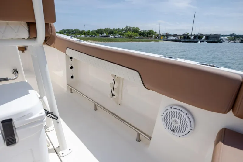 Slide: The Image of Interior view of 2022 Pioneer 202 Islander boat with cushioned seating and speaker. - 25